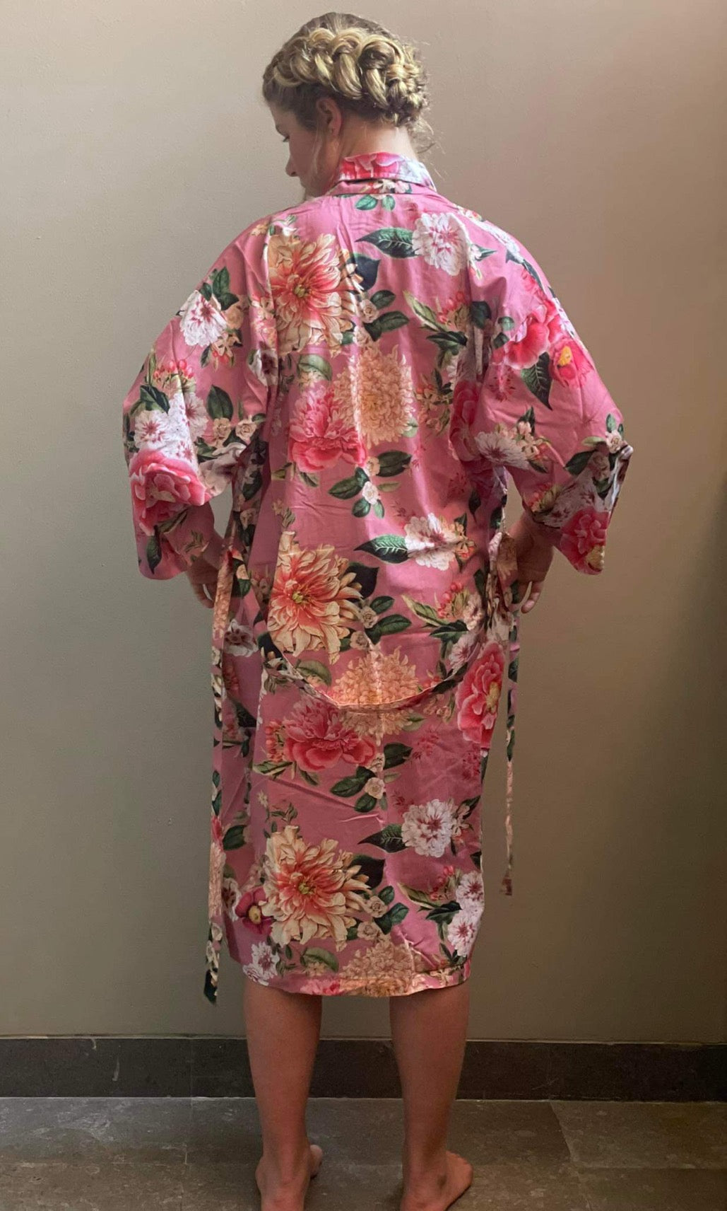 Woman in pink kimono robe with flowers
